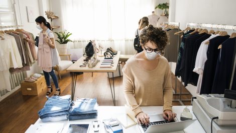 A female business owner is using the laptop